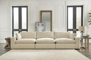 Ashley Furniture Elyza living room set with sofa and armchair, featuring neutral upholstery and modern design.