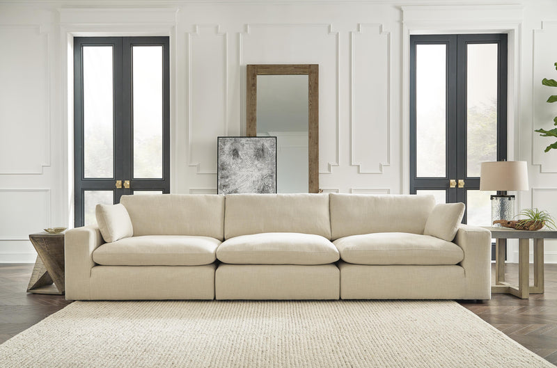 Ashley Furniture Elyza living room set with sofa and armchair, featuring neutral upholstery and modern design.