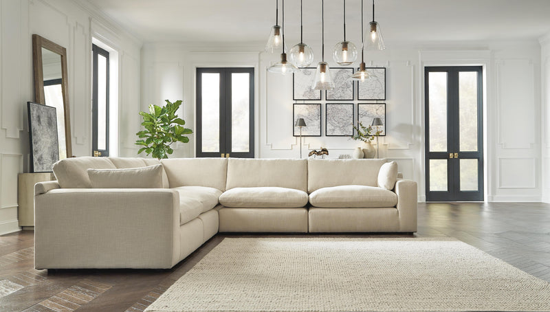 Ashley Furniture Elyza living room set with sofa and armchair, featuring neutral upholstery and modern design.