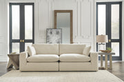 Ashley Furniture Elyza living room set with sofa, loveseat, and armchair in neutral fabric, arranged in a modern living space.