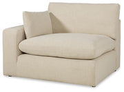 Ashley Furniture Elyza living room set featuring a sofa and loveseat with plush cushions and modern design, shown from an angled view.