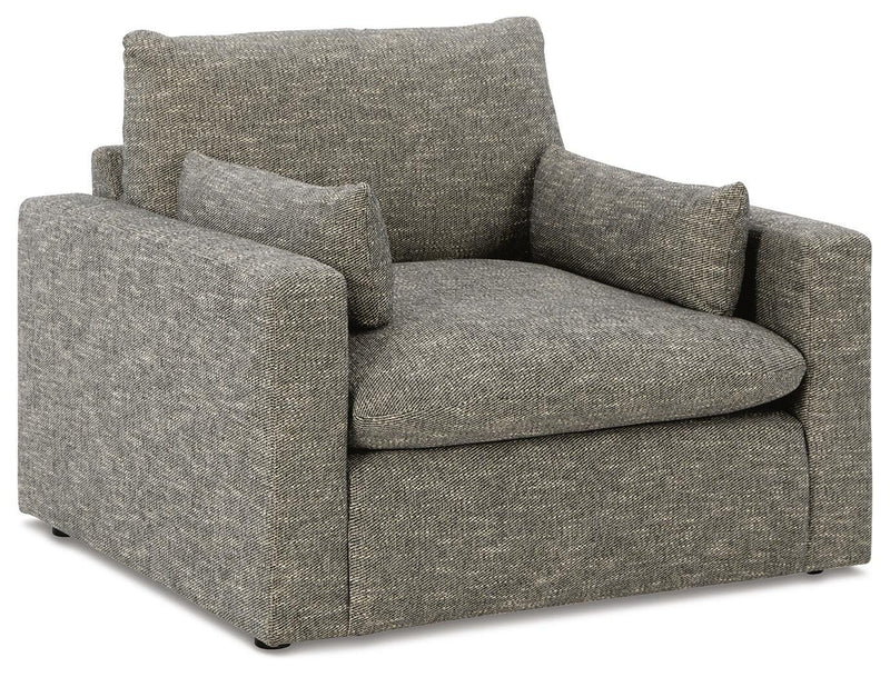 Ashley Furniture dramatic living room set with plush sofas and armchairs arranged in a modern style, showcased from an angled perspective.