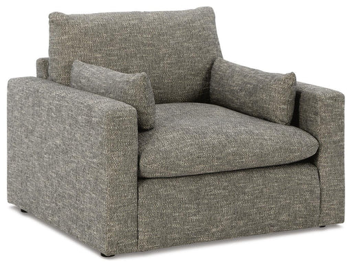 Oversized chair by Ashley Furniture with dramatic, plush upholstery and wide seating, shown from an angled side view.