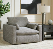 Large dramatic oversized chair by Ashley Furniture with plush fabric and modern design, perfect for a statement living room accent.
