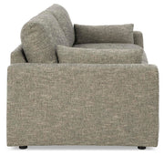 Ashley Furniture dramatic sofa with plush cushions and sleek design, shown from side angle in a modern living room setting.