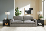 Dramatic sofa by Ashley Furniture featuring plush cushions, dark upholstery, and contemporary design in a stylish living room setting.