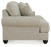 Ashley Furniture Asanti loveseat with plush beige upholstery and cushioned armrests, perfect for cozy living room seating.