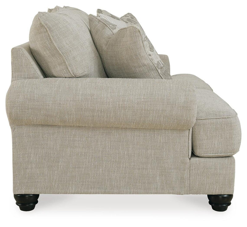 Ashley Furniture Asanti loveseat with plush beige upholstery and cushioned armrests, perfect for cozy living room seating.