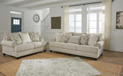 Ashley Furniture Asanti living room set with sofa, loveseat, and coffee table in a modern design, shown in a cozy living space.
