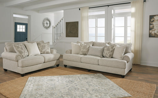 Ashley Furniture Asanti living room set with sofa, loveseat, and coffee table in a modern design, shown in a cozy living space.