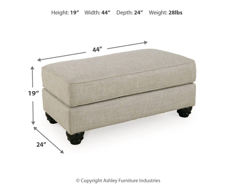 Ashley Furniture Asanti Ottoman with plush fabric and decorative wooden legs, ideal for living room or bedroom decor.