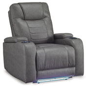 Ashley Furniture Schooner Rocks Power Recliner with plush cushioning and dark wood finish, shown from an angled closed position.