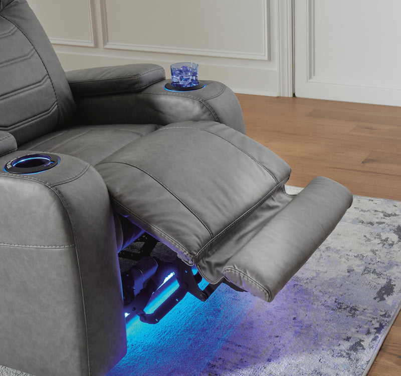 Ashley Furniture Schooner Rocks Power Recliner with plush upholstery and reclining feature, shown in a modern living room setting.
