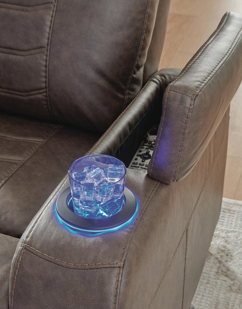 Ashley Furniture Schooner Rocks power recliner with armrest, cup holder, and headrest featuring plush upholstery and modern design.