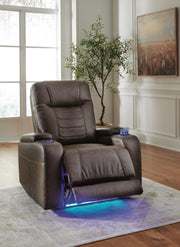 Open Ashley Furniture Schooner Rocks Power Recliner showing plush fabric and reclining mechanism in a modern living room setting.