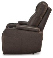 Ashley Furniture Schooner Rocks Power Recliner with plush upholstery and side controls, shown from the side in a well-lit living room setting.
