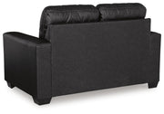 Ashley Furniture Barlin Mills loveseat with plush fabric and cushioned back, shown from the back view.