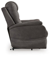 Ashley Furniture Snowfield Power Lift Recliner in beige fabric with padded armrests and plush cushioning, shown from side view.