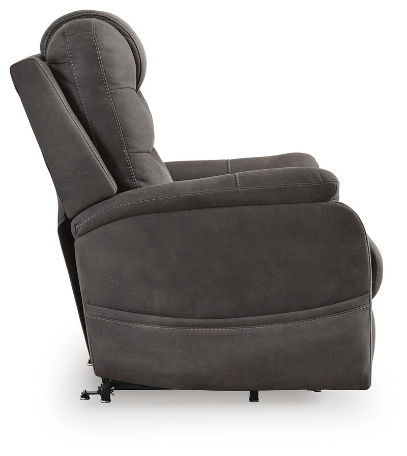 Ashley Furniture Snowfield Power Lift Recliner in beige fabric with padded armrests and plush cushioning, shown from side view.