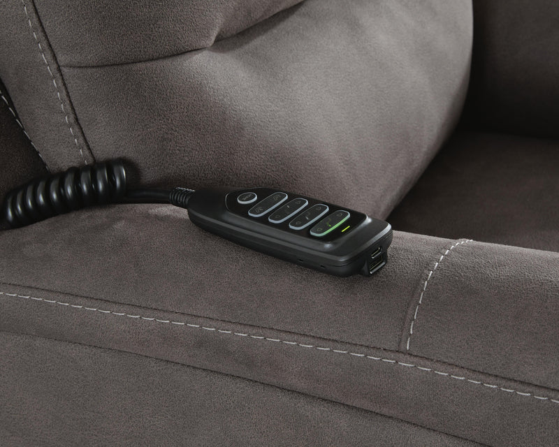 Ashley Furniture Snowfield Power Lift Recliner in beige fabric with plush cushioning and a built-in control panel.