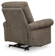 Ashley Furniture Aureta Power Lift Recliner with plush upholstery, showing the back and side view of the recliner in a living room setting.
