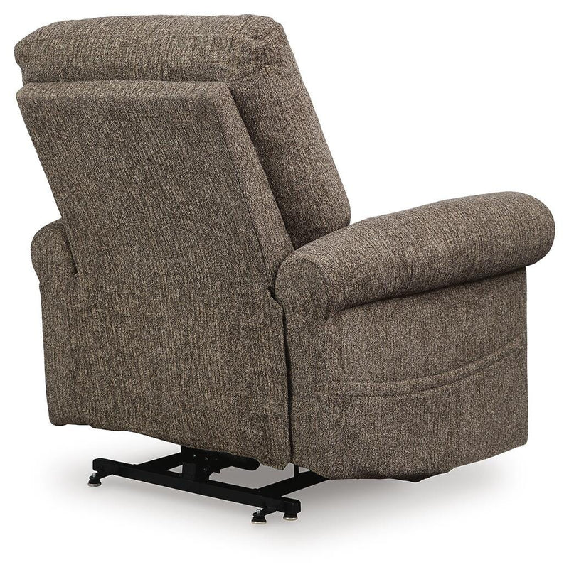 Ashley Furniture Aureta Power Lift Recliner with plush upholstery, showing the back and side view of the recliner in a living room setting.