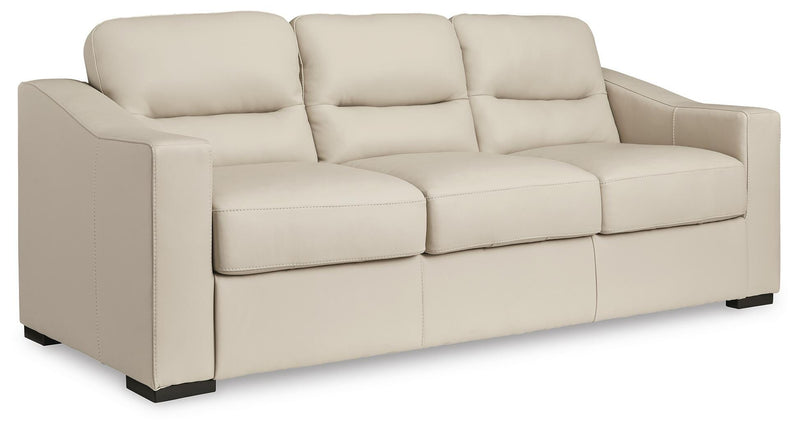 Ashley Furniture Treasure Trove sofa in beige fabric, angled view showing plush cushions and stylish armrests.