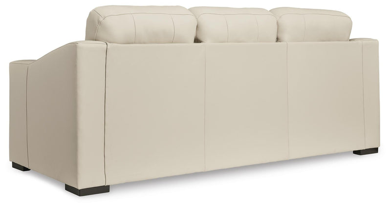 Ashley Furniture Treasure Trove sofa with plush cushions and dark wood legs, shown from the back in a modern living room setting.