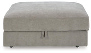 Ashley Furniture Aslan Court Ottoman with storage, featuring a plush upholstered top and wooden legs in a modern design.
