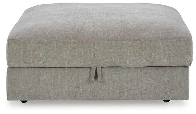 Ashley Furniture Aslan Court Ottoman with storage, featuring a plush upholstered top and wooden legs in a modern design.