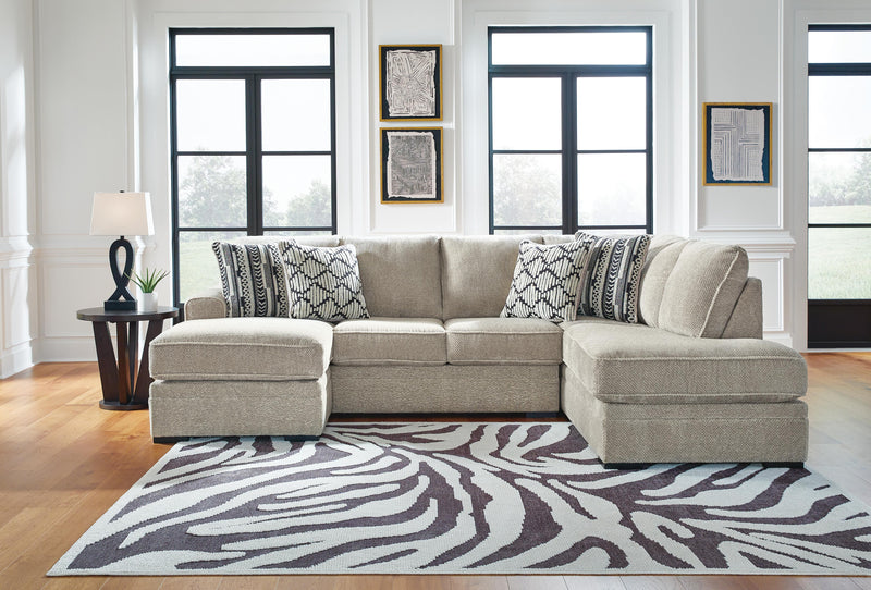 Ashley Furniture Calnita sectional with chaise, featuring plush fabric and modern design, shown in a stylish living room setting.