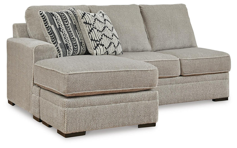 Ashley Furniture Calnita sectional with chaise, featuring plush upholstery and modern design, shown from an angled view.