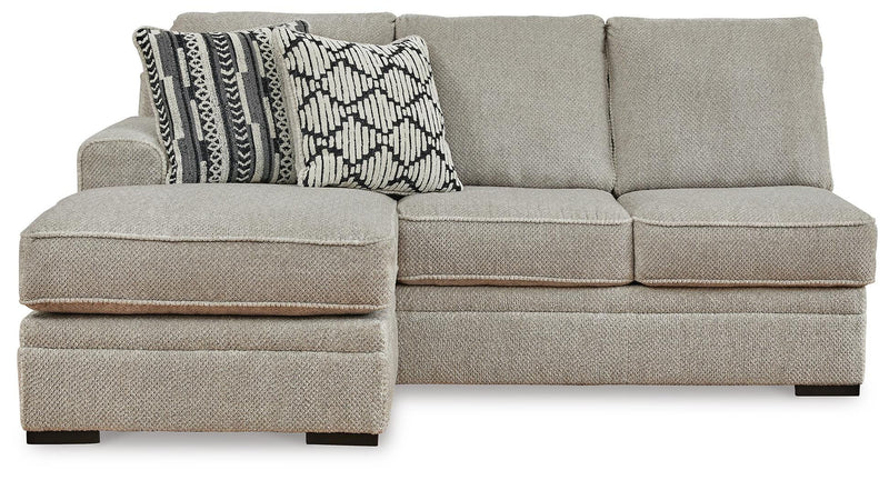 Ashley Furniture Calnita sectional with chaise, beige fabric, featuring plush cushions and a modern design, front view.