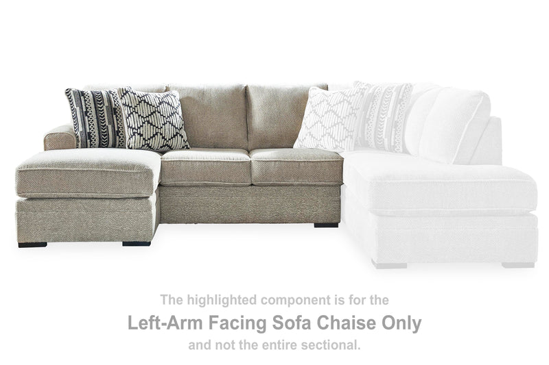 Ashley Furniture Calnita sectional with chaise, showcasing plush fabric upholstery and modern design in a spacious living room setting.