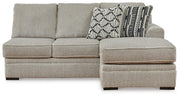 Ashley Furniture Calnita sectional with chaise showing plush fabric, modern design, and comfortable seating arrangement.