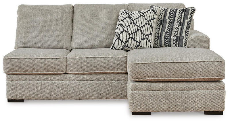 Ashley Furniture Calnita sectional with chaise showing plush fabric, modern design, and comfortable seating arrangement.