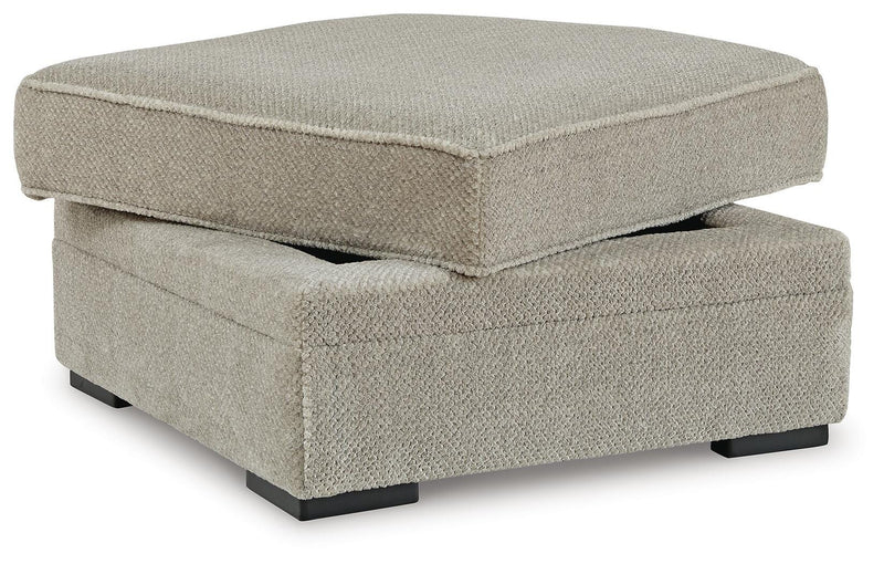 Ashley Furniture Calnita Ottoman with open storage, upholstered in fabric, showing its soft top and spacious interior from an angled view.
