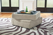 Open Ashley Furniture Calnita Ottoman with storage, showcasing its upholstered top and spacious interior for versatile use.