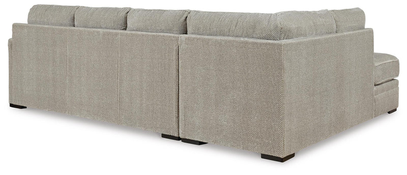 Ashley Furniture Calnita sectional with chaise, showing plush fabric and modern design, viewed from the back.