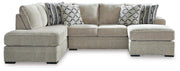 Ashley Furniture Calnita sectional with chaise showing plush fabric, modern design, and spacious seating arrangement.
