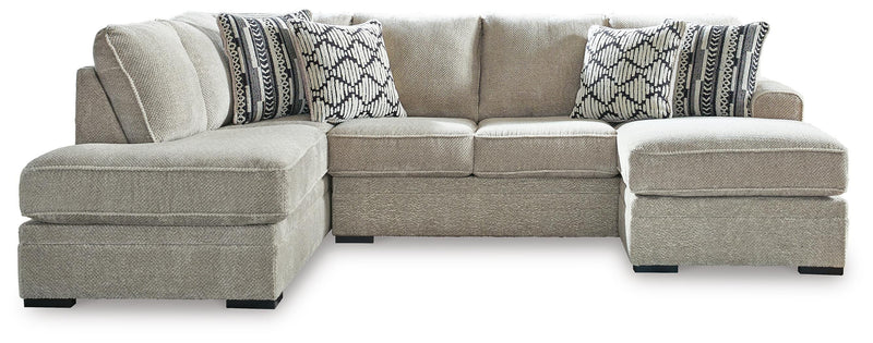 Ashley Furniture Calnita sectional with chaise showing plush fabric, modern design, and spacious seating arrangement.