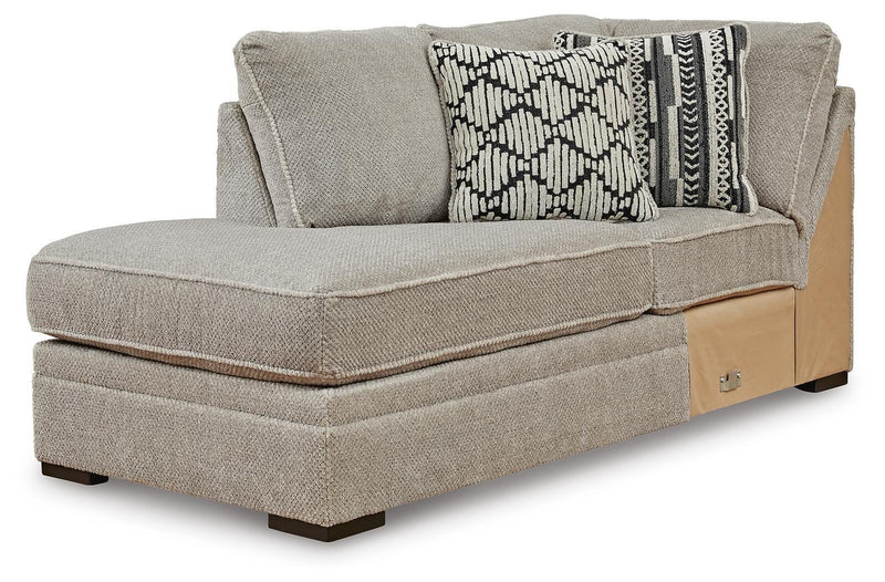 Ashley Furniture Calnita sectional with chaise, featuring plush cushions and stylish fabric, shown from an angled view.