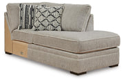 Ashley Furniture Calnita sectional with chaise, featuring plush fabric and modern design, shown from an angled side view