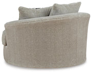 Ashley Furniture Calnita oversized swivel accent chair with plush upholstery and modern design, shown from the back.