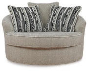 Ashley Furniture Calnita oversized swivel accent chair with plush fabric and modern design, shown from front view.