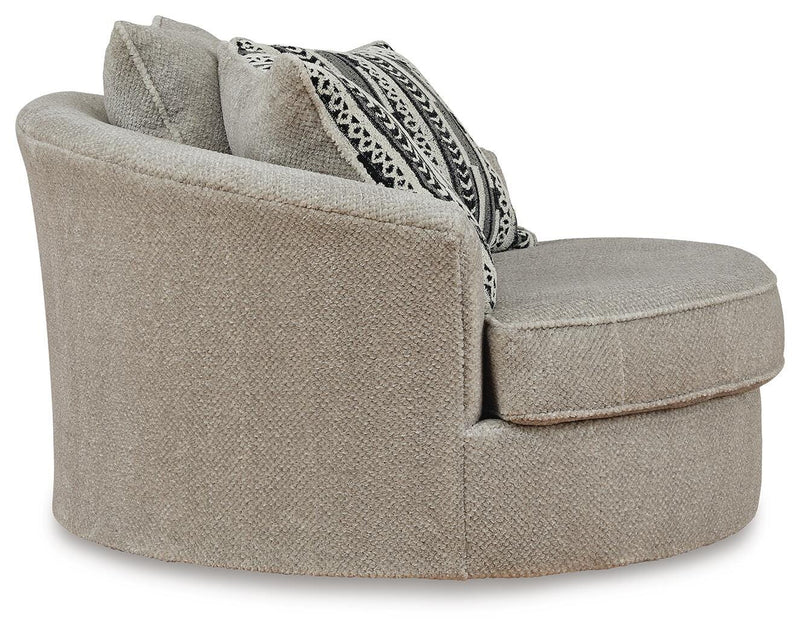 Ashley Furniture Calnita oversized swivel accent chair with plush upholstery and a modern design, shown from the side.