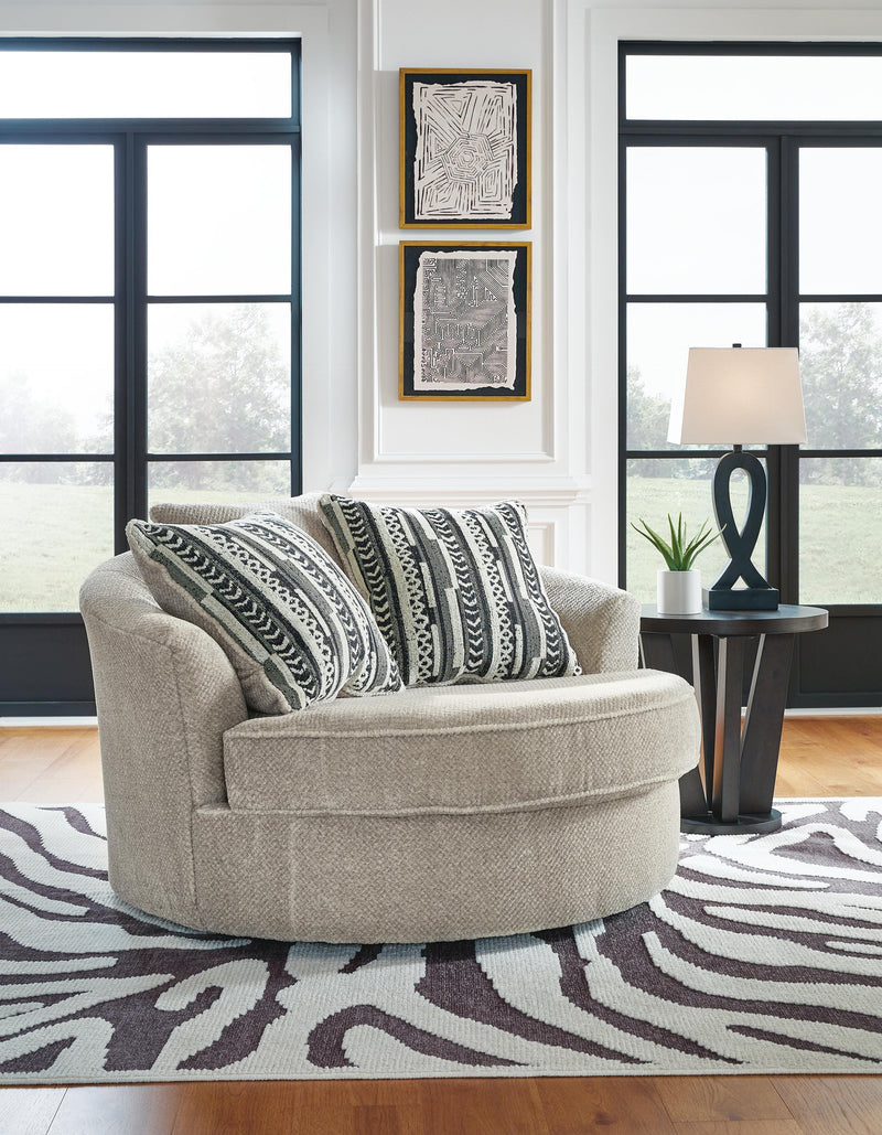 Ashley Furniture Calnita oversized swivel accent chair with plush fabric and wide, comfortable seating in a modern design.