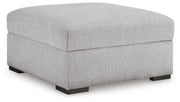 Ashley Furniture Gabyleigh Ottoman with storage, featuring a plush upholstered seat and wooden legs in a modern design.