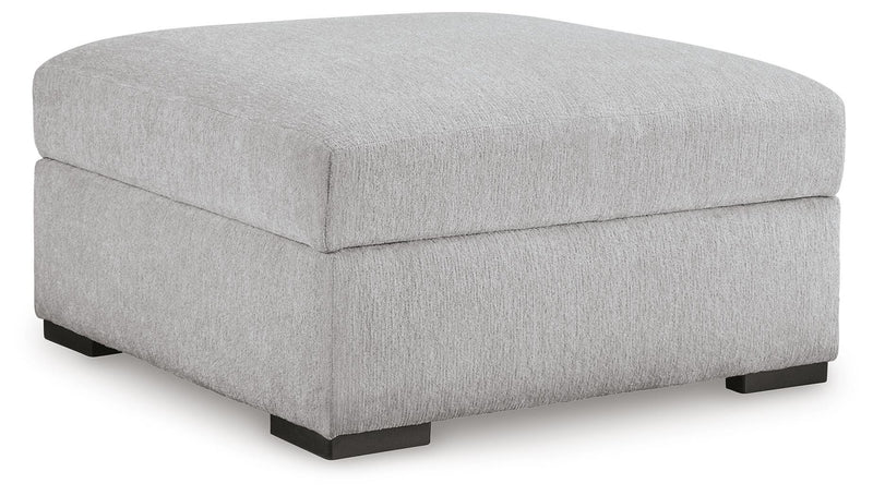 Ashley Furniture Gabyleigh Ottoman with storage, featuring a plush upholstered seat and wooden legs in a modern design.