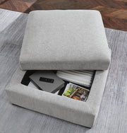 Open Ashley Furniture Gabyleigh Ottoman with storage, showing its upholstered top and spacious interior for versatile use.